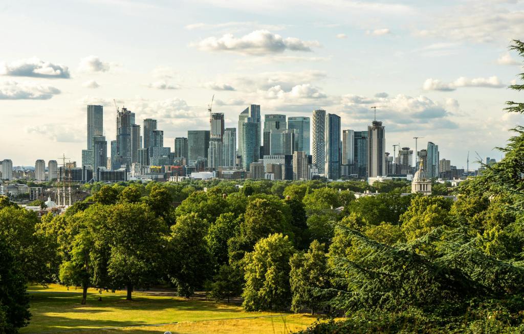 City of London with green trees and park in the foreground
